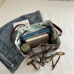 Mint green bow backpack with star lining and spacious interior for tablets and books
