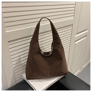 Detailed macro view of large leopard print hobo tote bag with matte faux suede texture