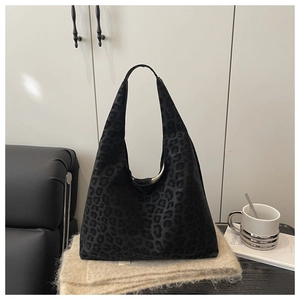 Close-up of velvet leopard print tote bag with subtle dark patterns on soft fabric