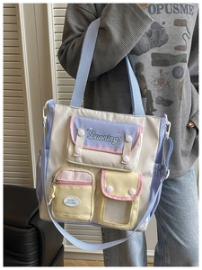 Detail of macaron patchwork shoulder bag with multiple functional pockets and adjustable strap