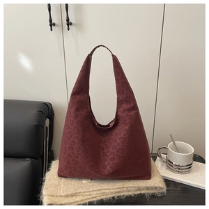 Close-up of vintage burgundy leopard print tote bag in a stylish lifestyle home setting