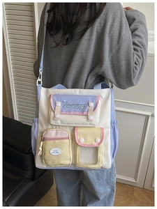 Detail view of colorful multi-pocket crossbody bag with adjustable shoulder strap