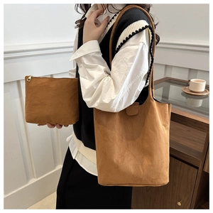 Detail of caramel brown suede tote bag with matching inner pouch for daily commuting