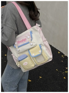 Detail of multi-pocket canvas school bag with pastel macaron colors and side view capacity