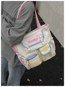 Detail of color-block canvas bucket bag with functional multi-pockets and secure zippers