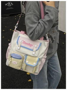 Close-up of multi-pocket patchwork canvas crossbody bag with pastel color blocks