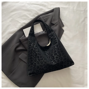 Flat lay of black leopard print tote bag with a high-quality velvet-like texture finish