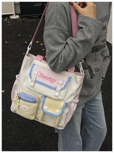 Side view of multi-pocket nylon crossbody bag with color-block design in a campus style
