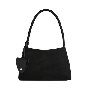 Elegant black faux suede underarm bag with decorative strap knot and mini pouch charm