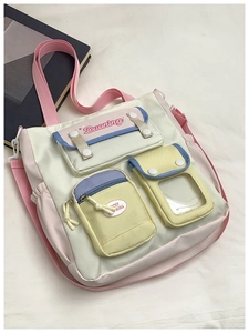 Detail of multi-pocket canvas crossbody bag with pastel panels and adjustable strap
