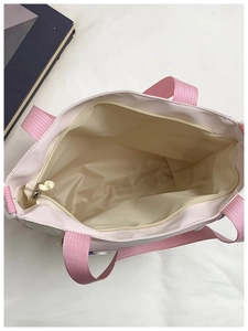 Pink canvas tote interior view showing main compartment and inner zipper pocket details