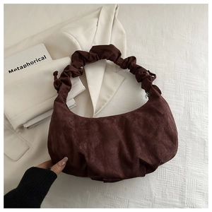 Vue détaillée du sac croissant en daim marron foncé avec anse plissée et texture douce
