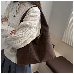 Detail of large leopard print hobo bag showing fuzzy texture and spacious capacity
