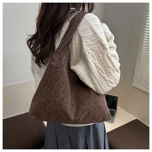 Detail of matte leopard print tote bag showing soft suede texture and spacious interior