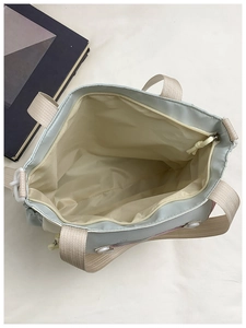 Detail view of large school tote bag with spacious interior and beige fabric handles