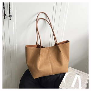 Close-up of brown suede tote bag showing soft texture and vintage commuter style