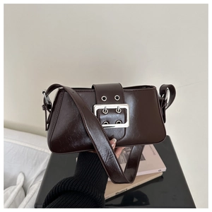 Detail of vintage dark brown leather underarm bag featuring a bold silver square buckle