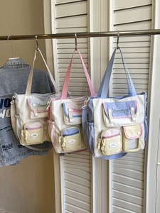 Three color-block canvas tote bags with adjustable straps and multi-pocket college style