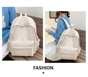 Detail eines cremeweißen Cord-Rucksacks mit strukturierter Oberfläche und Seil-Reißverschluss
