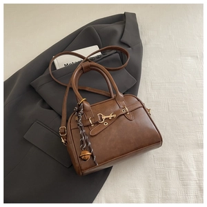 Brown retro shell crossbody bag with matte PU leather finish and gold hardware accents