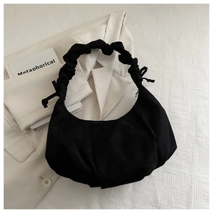 Vue détaillée du sac hobo noir avec poignée froncée et nœuds décoratifs latéraux