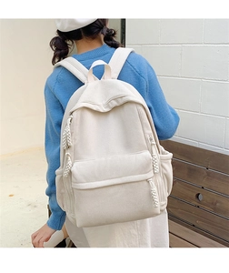 Detail eines cremeweißen Cord-Rucksacks mit gewebtem Seil-Reißverschluss am Rucksack