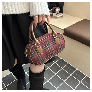 Detailed macro of vintage plaid mini Boston bag with brown faux leather trim and gold zippers