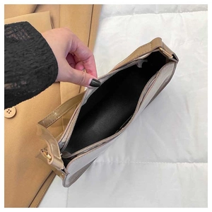 Detail view of contrast color underarm bag showing zipper closure and interior capacity