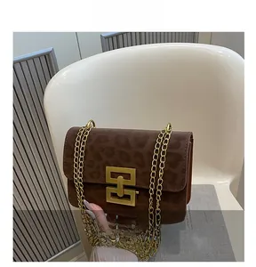 Detail show of leopard print suede crossbody bag with gold square metal clasp and chain