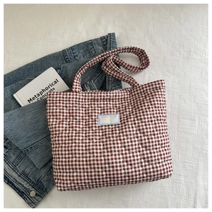 Detail of red gingham tote bag with heart quilting and Soitakica Studio label