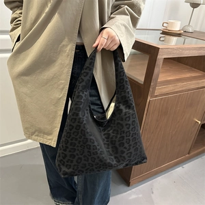 Retro dark leopard print large hobo bag styled with a trench coat for daily commuting