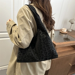 Vintage black leopard print large tote bag worn with a khaki trench coat