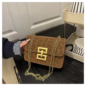 Close-up of leopard print crossbody bag with gold geometric lock and chain strap