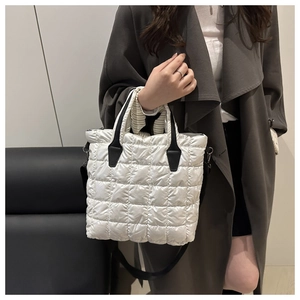 Detailed view of quilted cotton puffer tote bag with black strap and top handles