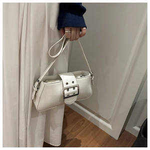 Detail of a white matte leather vintage baguette bag with a silver square buckle