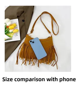 Brown faux suede tassel crossbody bag size comparison with a smartphone on white background
