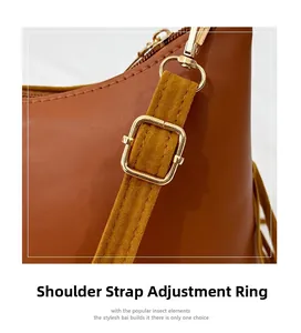 Detail of adjustable golden metal buckle on brown suede shoulder strap with precise stitching