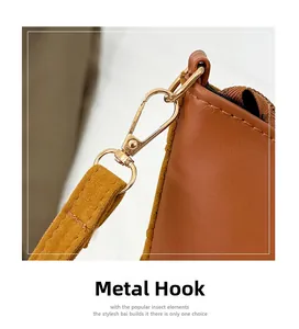 Detail of premium gold hardware hook and caramel brown leather strap on tote bag