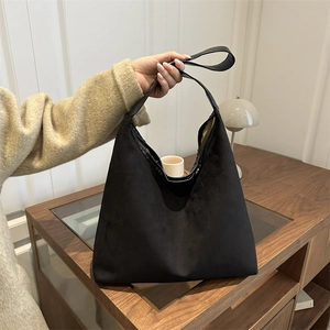 Minimalist black faux suede large tote bag for women featuring a matte hobo design