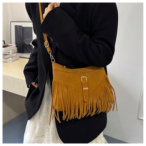 Brown suede crossbody bag featuring long bohemian tassels and a golden buckle detail
