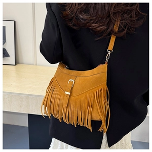 Detail of bohemian ginger yellow suede tote bag with long fringe and gold buckle