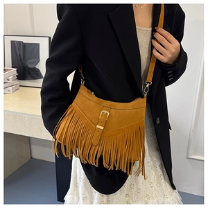 Close-up of yellow fringe tote bag with matte suede texture and metal buckle detail