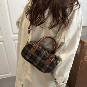 Mini plaid Boston bag in brown checkered fabric with leather trim on model