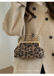Detail of leopard print shell bag with vintage gold metal handle and chain strap