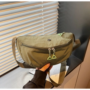 Detail of olive green nylon crescent bag showing zipper pullers and adjustable strap