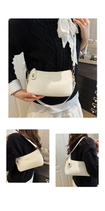 Close-up of cream textured leather bag featuring gold hardware and fashion lettering