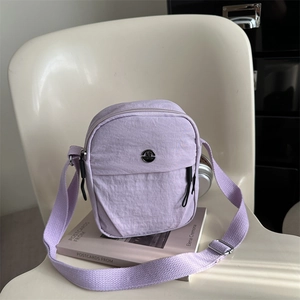 Light purple lightweight nylon crossbody bag with adjustable strap and M logo