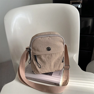 Versatile khaki nylon shoulder bag with multi-zipper pockets and minimalist design