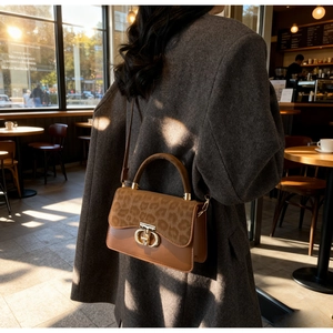 Close-up of retro leopard print flap and brown leather crossbody bag with gold lock