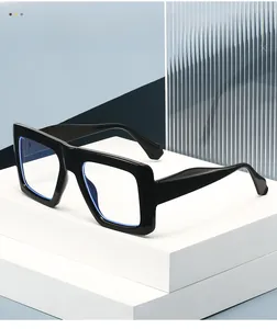 Detail view of thick square black frame glasses with blue light blocking lens coating